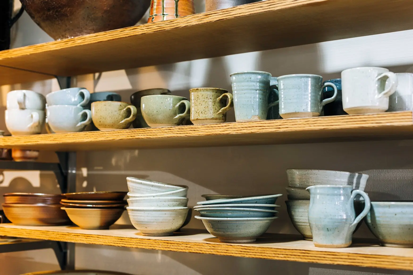 Ceramic homewares on a shelf